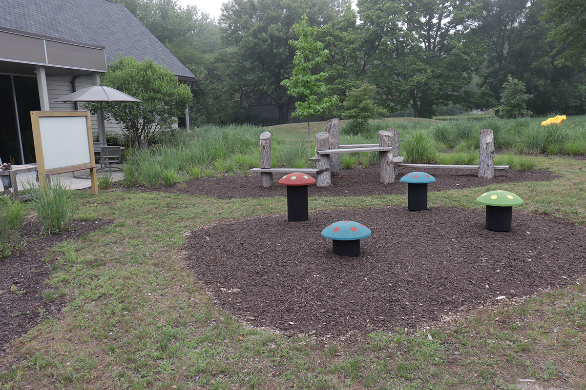 Outdoor Exploration Space at Fish Lake Branch showing the mushroom stools