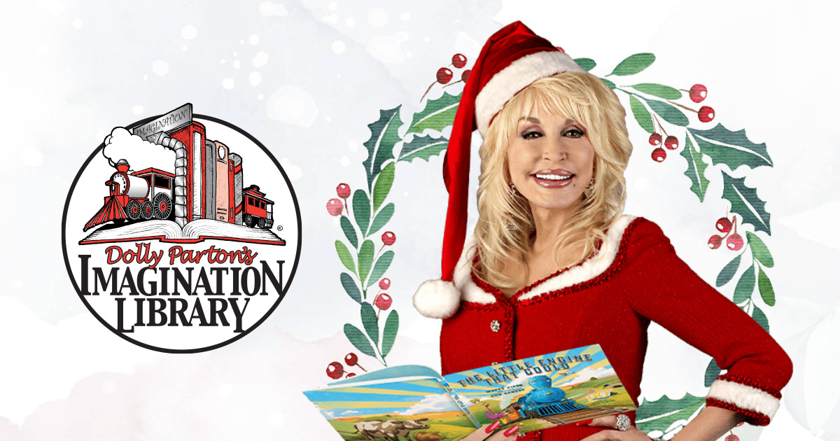 Dolly Parton holding a book and wearing a santa hat.